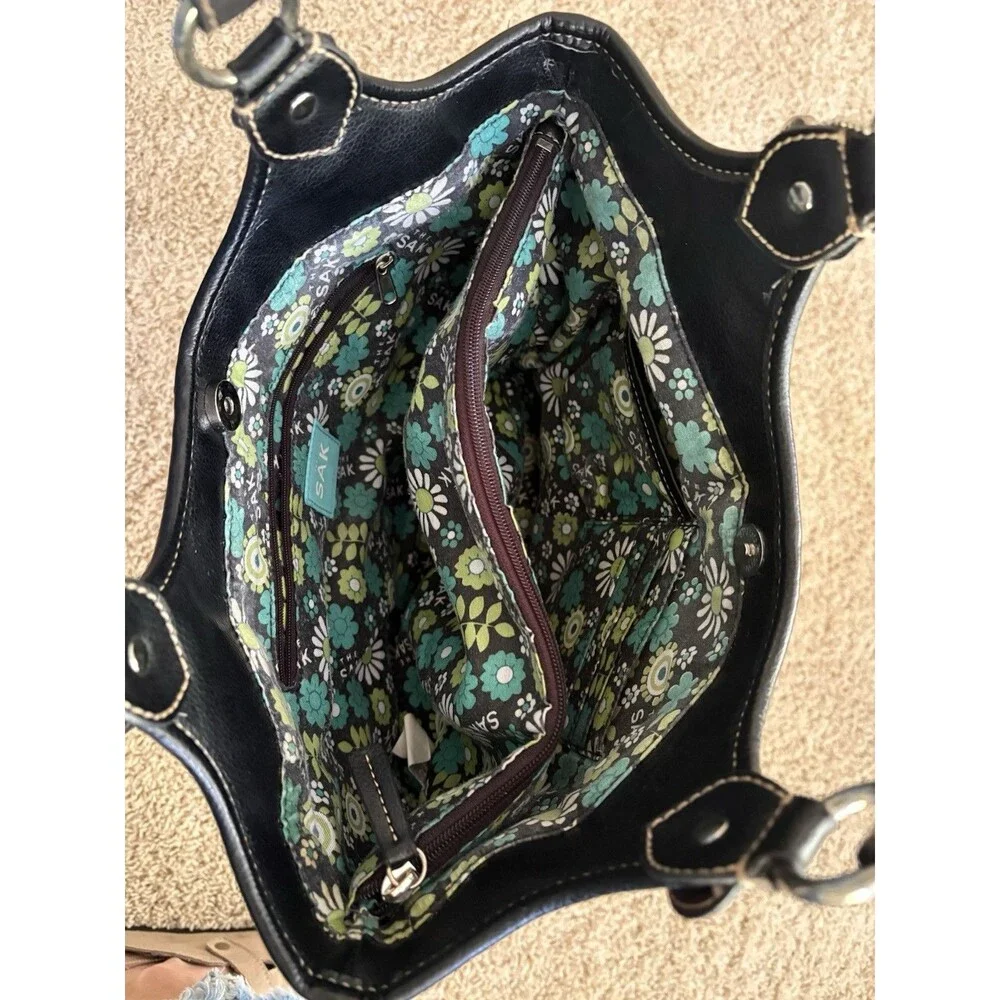 The Sak Black Pebbled Leather Shoulder Bag Buckles Silver Hardware Stitching